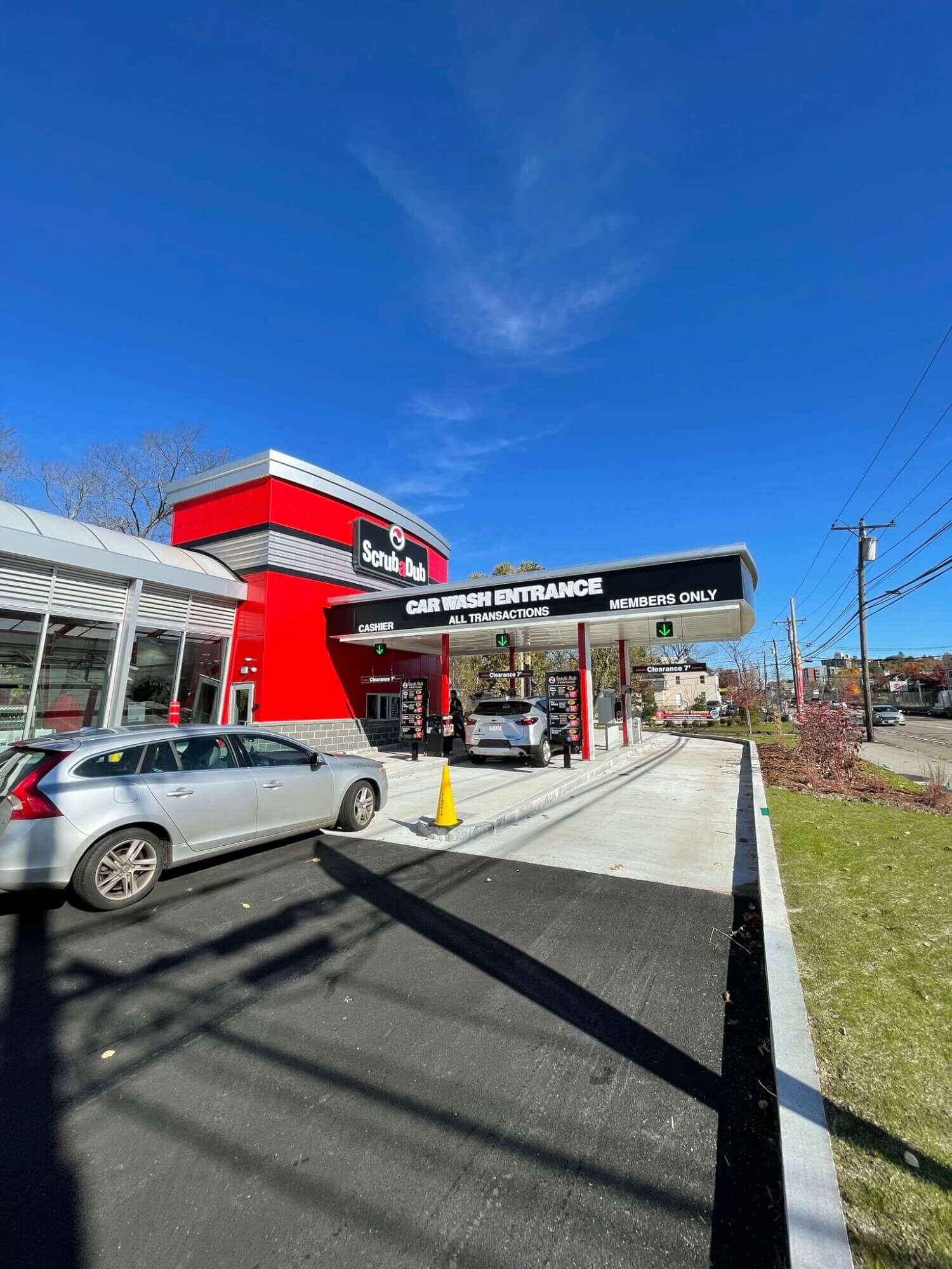ScrubaDub Framingham pay lanes under a "Car Wash Entrance / Members Only" canopy beside the red tower