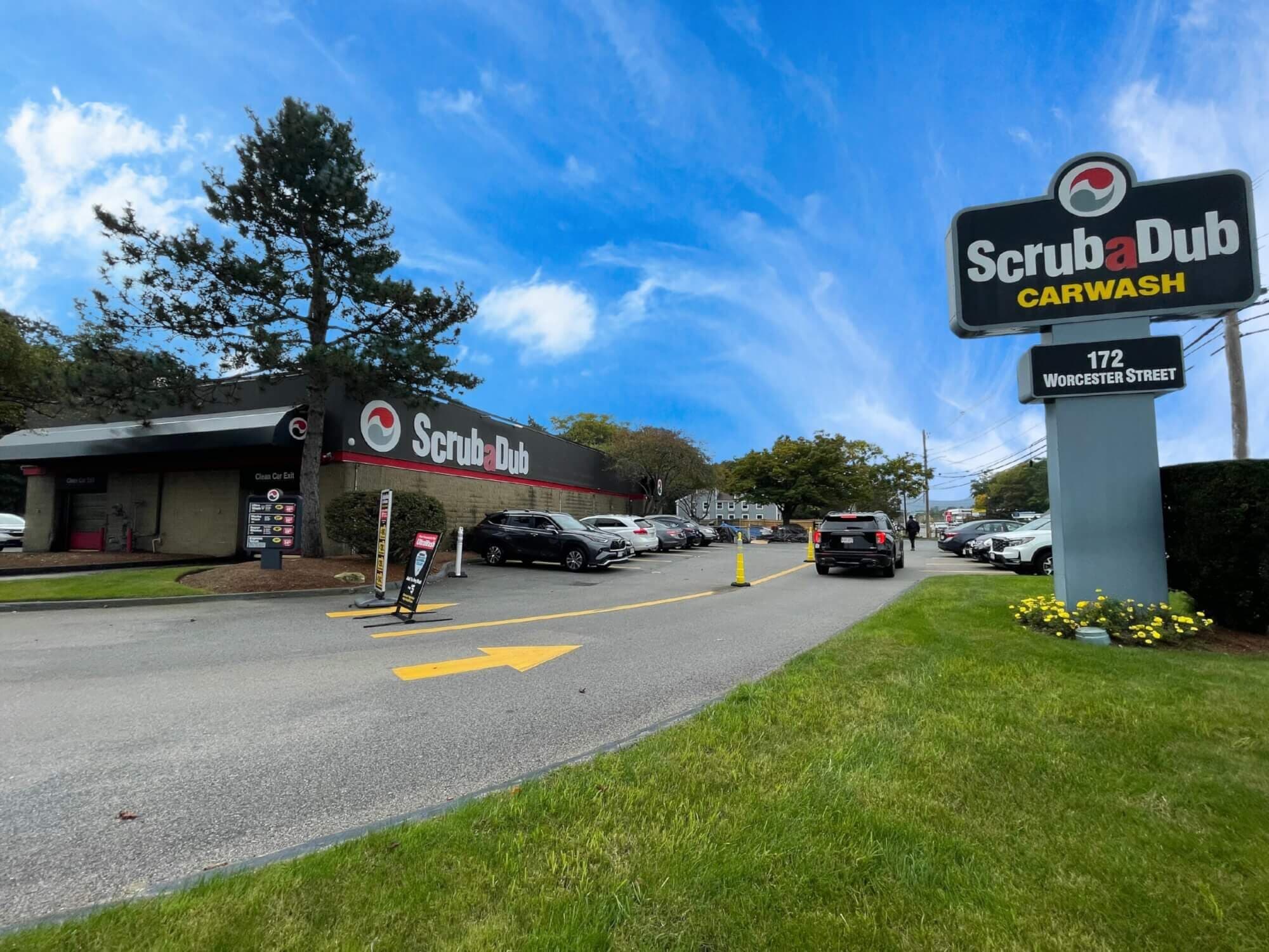 ScrubaDub Carwash pylon sign at 172 Worcester Street in Natick, with cars lined up at the building