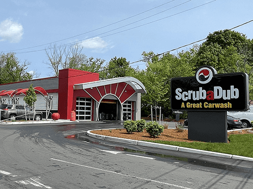 ScrubaDub Roslindale car wash with a red sunburst entrance and A Great Carwash sign