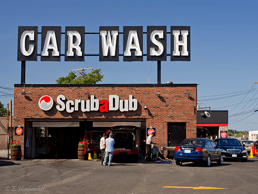 Brick ScrubaDub car wash in Dorchester topped by giant CAR WASH letters