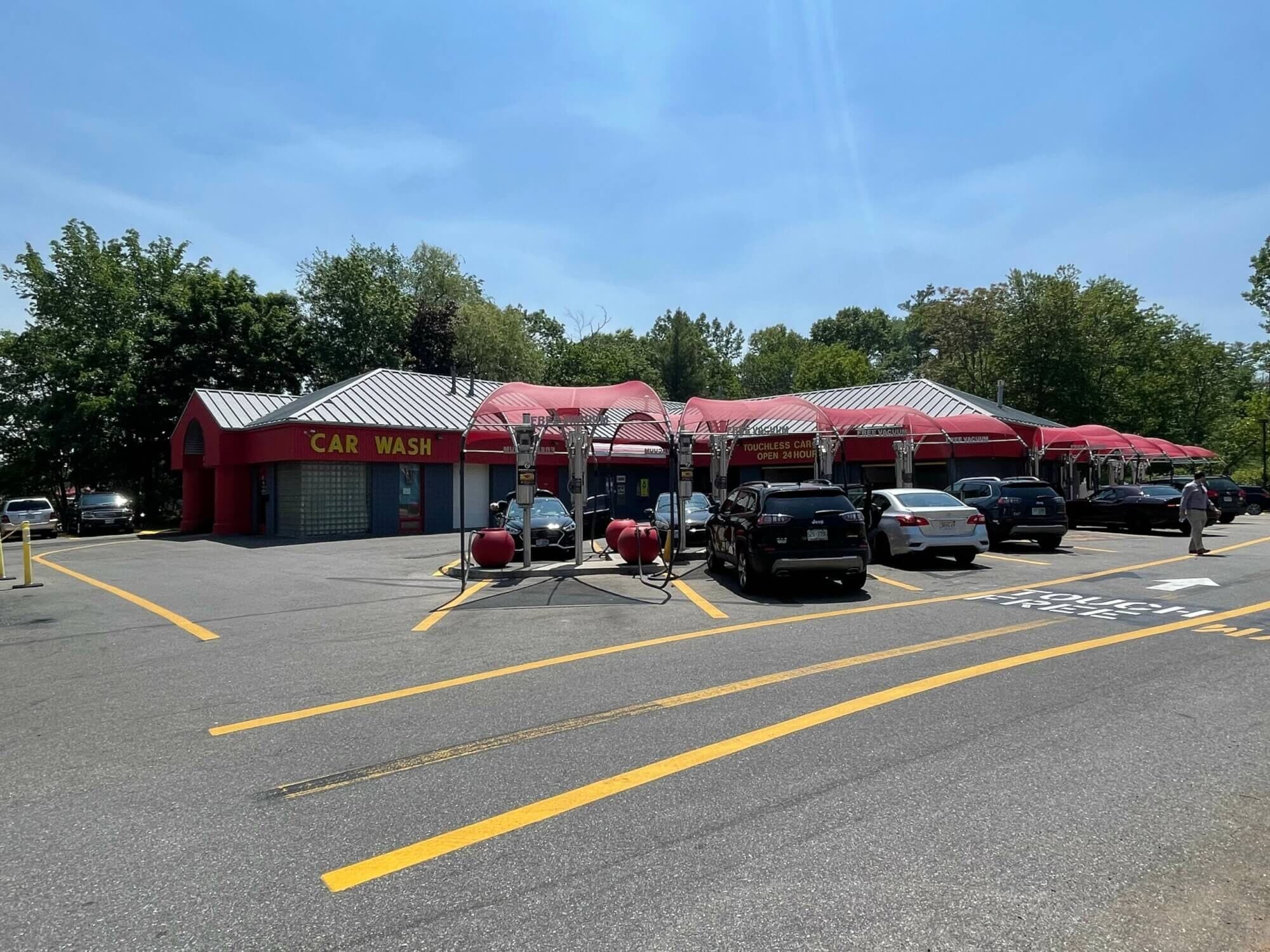 ScrubaDub Salem car wash with a yellow "Car Wash" sign and a long row of red vacuum canopies