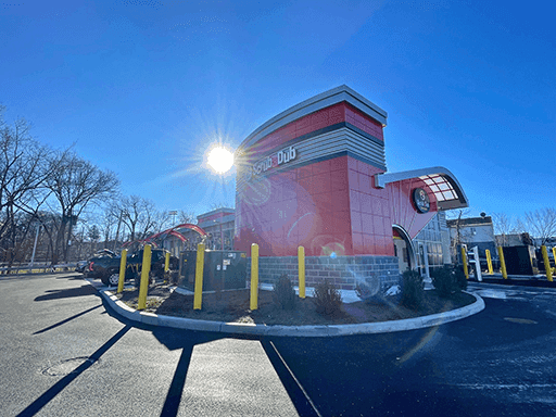 ScrubaDub Park Avenue car wash tower with sun flare behind it