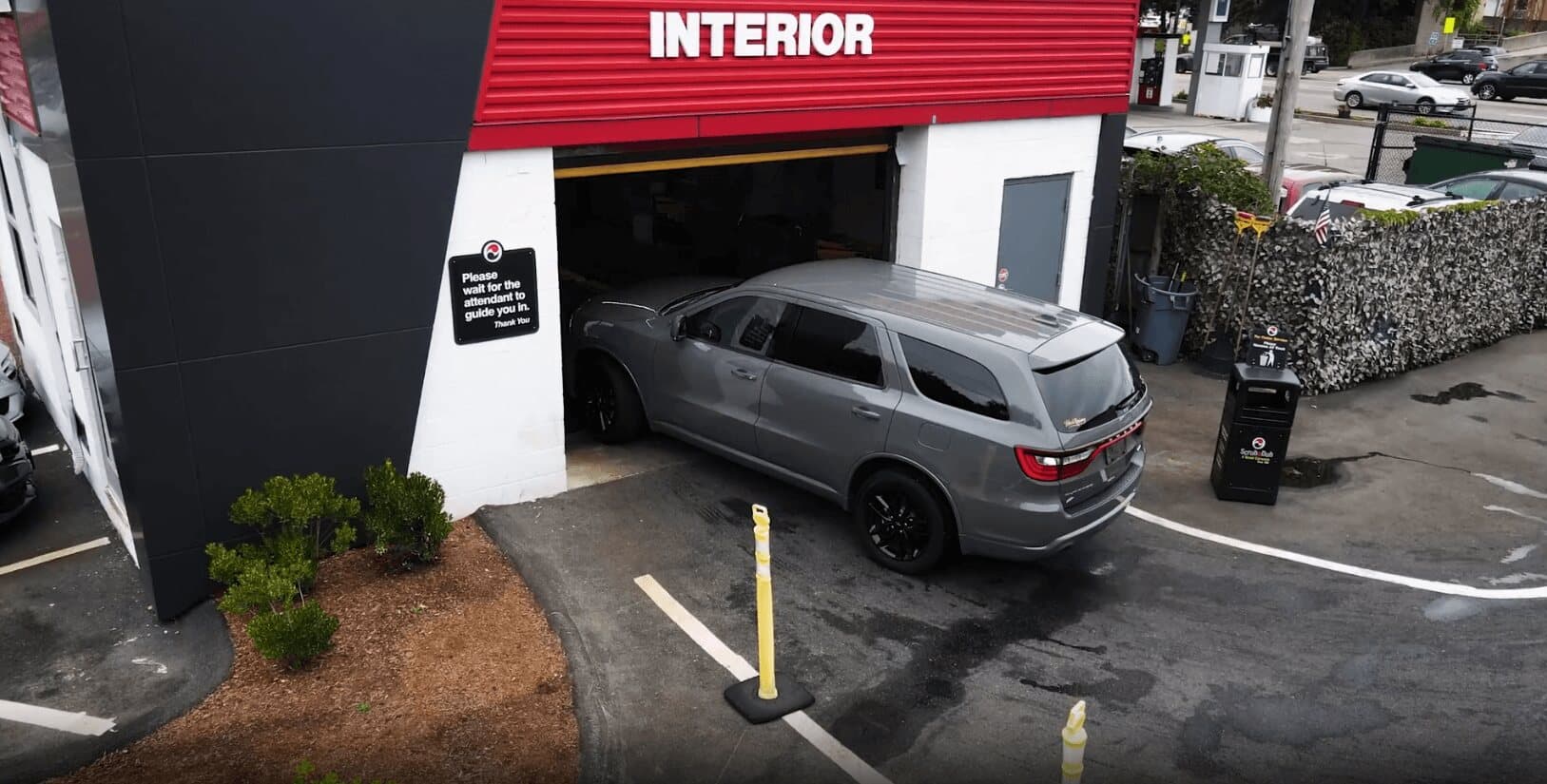 Gray SUV pulling into a ScrubaDub bay marked Interior, seen from above